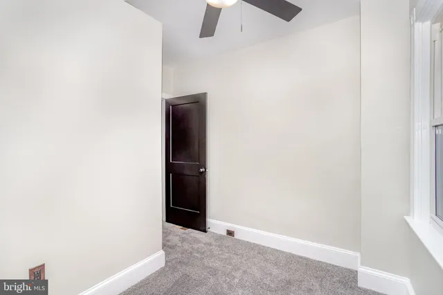 a view of a room with a fan and a ceiling fan