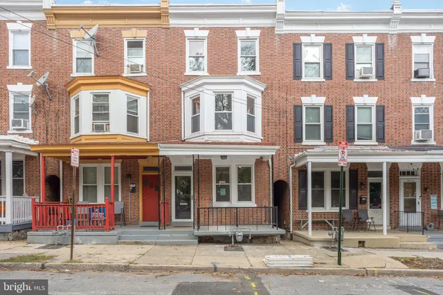 a sign on top of a white wall