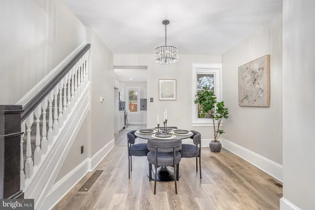 a view of a dining room with furniture wooden floor and a chandelier