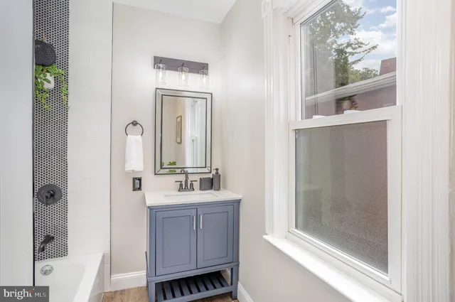 a bathroom with a bathtub a sink and a mirror
