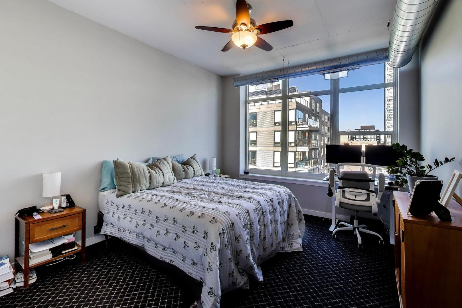 909 West Washington Boulevard, Unit 811 Chicago, IL 60607 - Photo 11 of 28 a bedroom with a bed and a couch