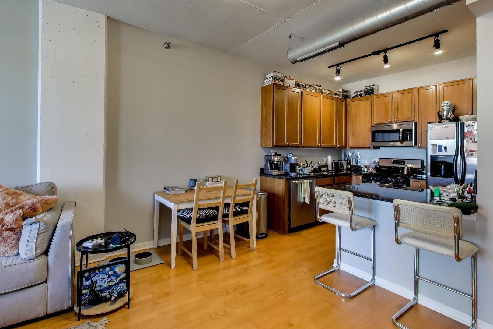 909 West Washington Boulevard, Unit 811 Chicago, IL 60607 - Photo 8 of 28 a kitchen with stainless steel appliances a stove a sink and a refrigerator