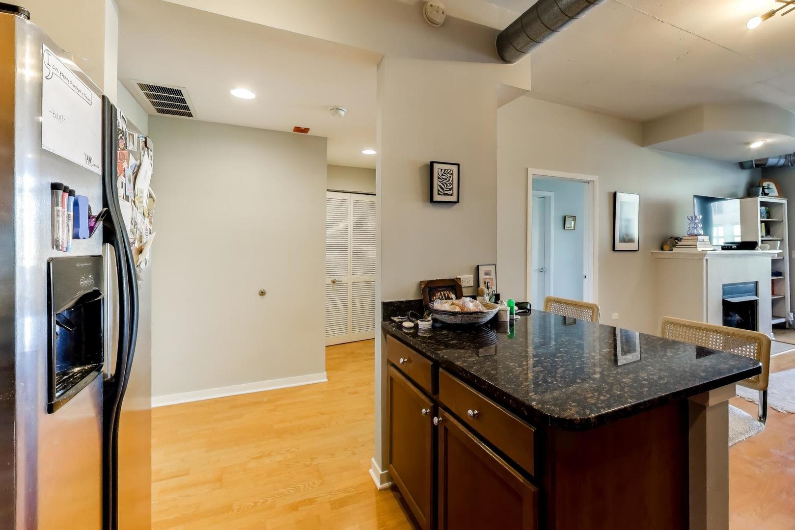 909 West Washington Boulevard, Unit 811 Chicago, IL 60607 - Photo 10 of 28 a kitchen with stainless steel appliances granite countertop a sink a refrigerator and a stove