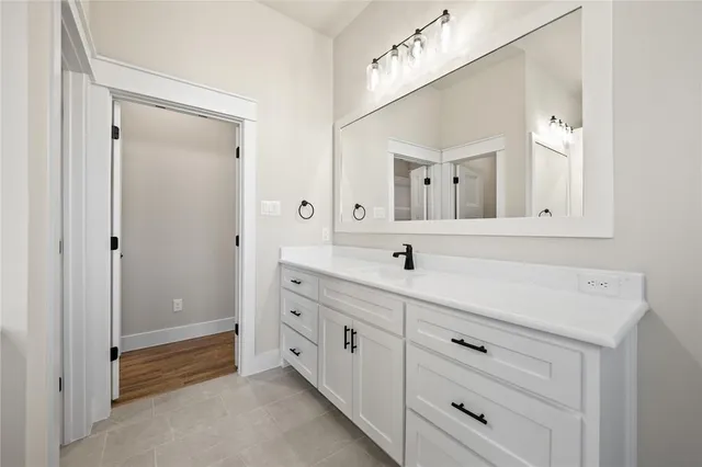 a bathroom with a double vanity sink mirror and
