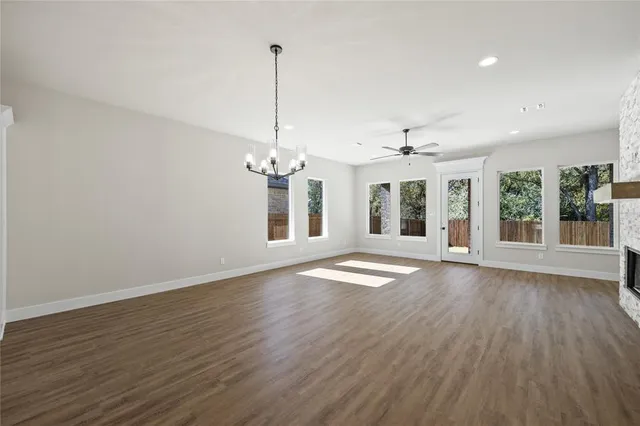 a kitchen with stainless steel appliances granite countertop a sink a stove and a refrigerator