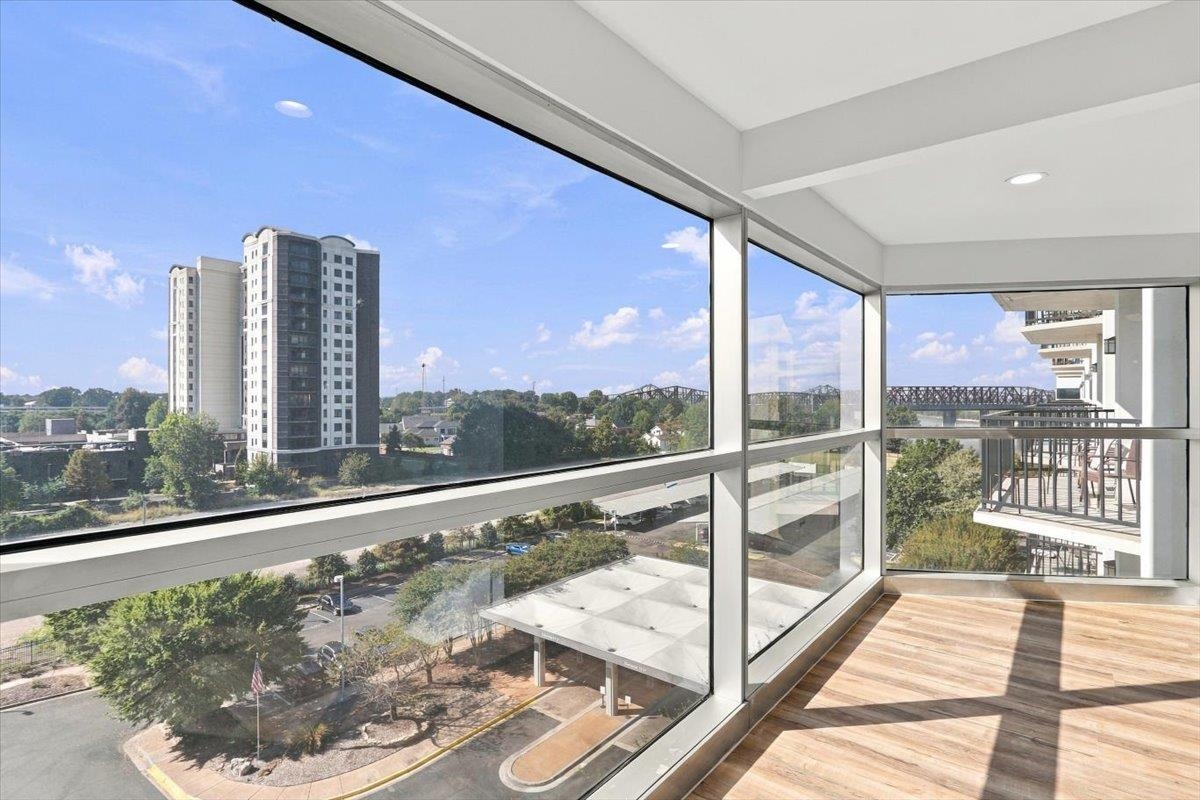 655 Riverside Drive, Unit 608B Memphis, TN 38103 - Photo 1 of 28 Expansive full-height windows, wood-finish flooring, recessed lighting, and a glass-paneled railing
