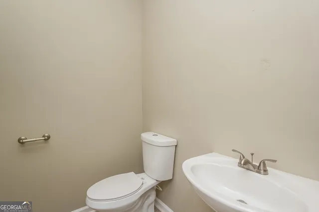 a white toilet sitting next to a white sink