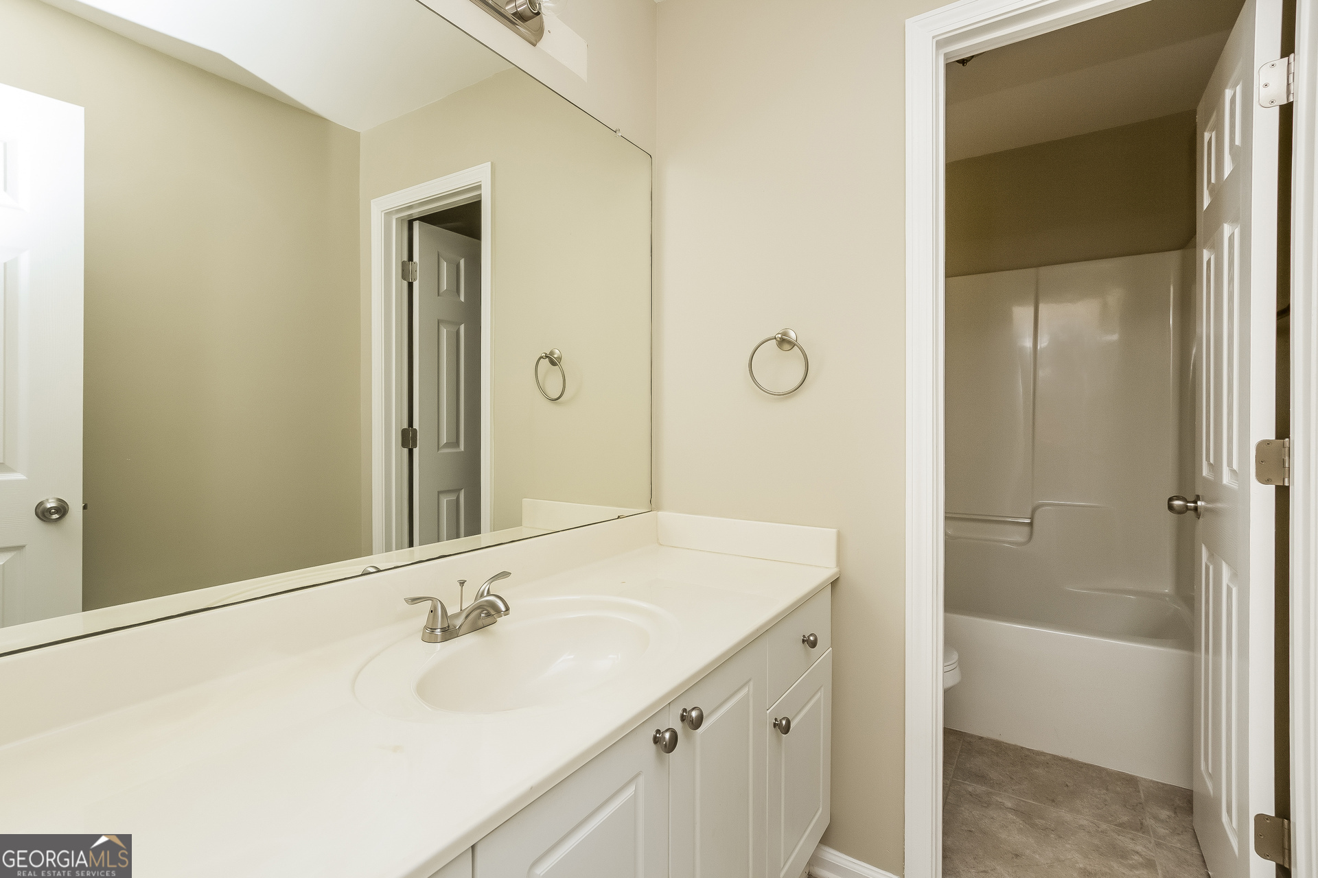 5892 Village Loop Fairburn, GA 30213 - Photo 14 of 15 a bathroom with a sink and a mirror