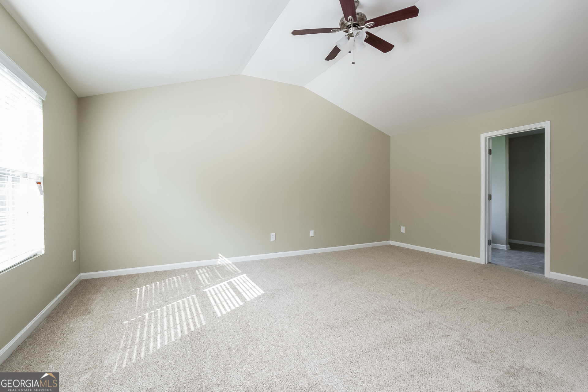 5892 Village Loop Fairburn, GA 30213 - Photo 5 of 15 an empty room with a window and a fan
