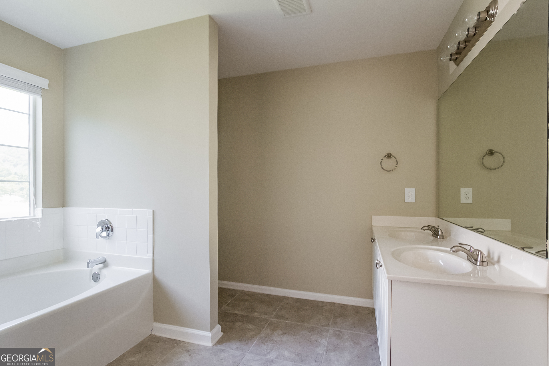 5892 Village Loop Fairburn, GA 30213 - Photo 6 of 15 a bathroom with a tub sink and mirror