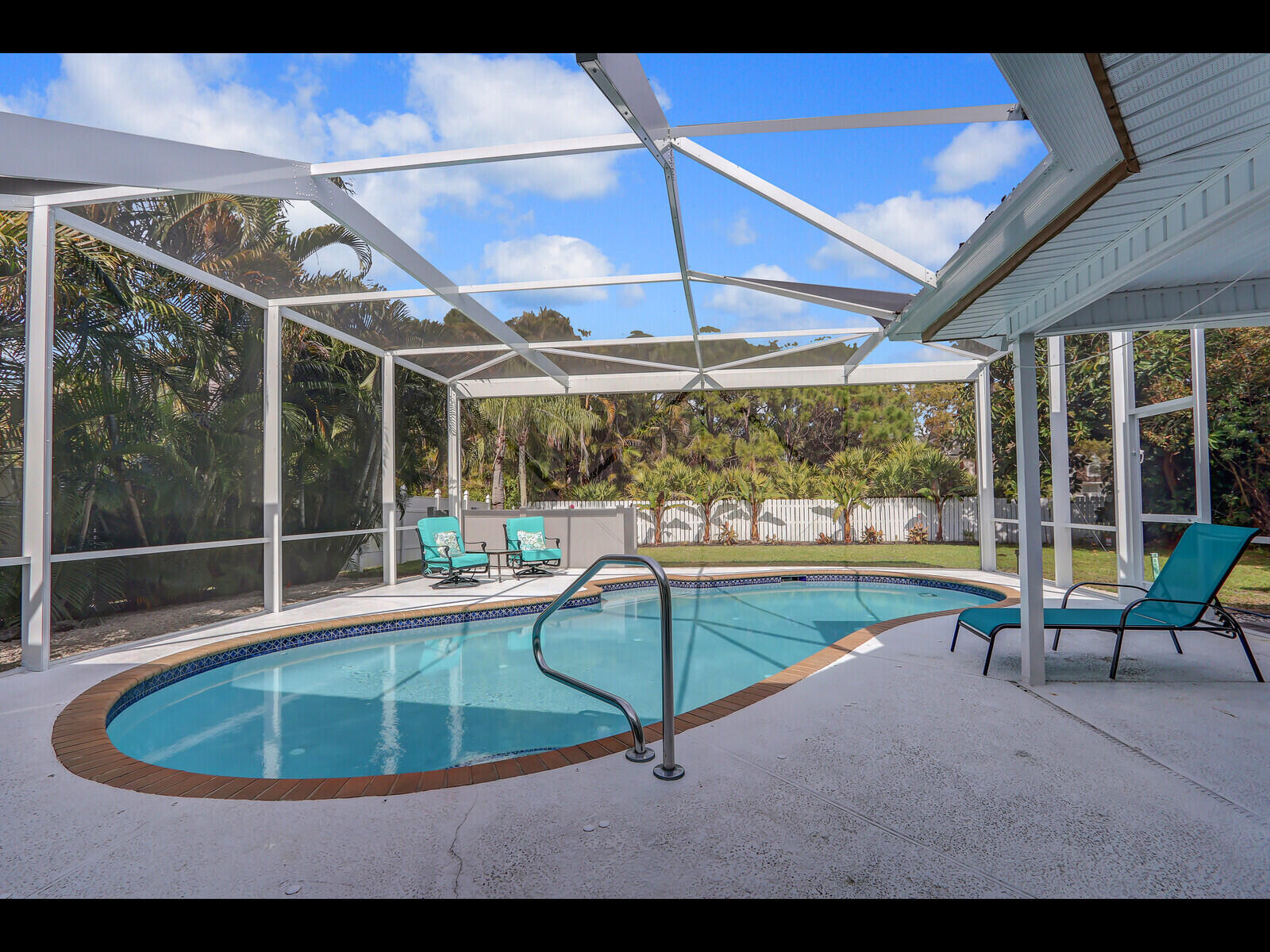 609 Oak Terrace Jupiter, FL 33458 - Photo 1 of 28 a swimming pool with outdoor seating yard and patio