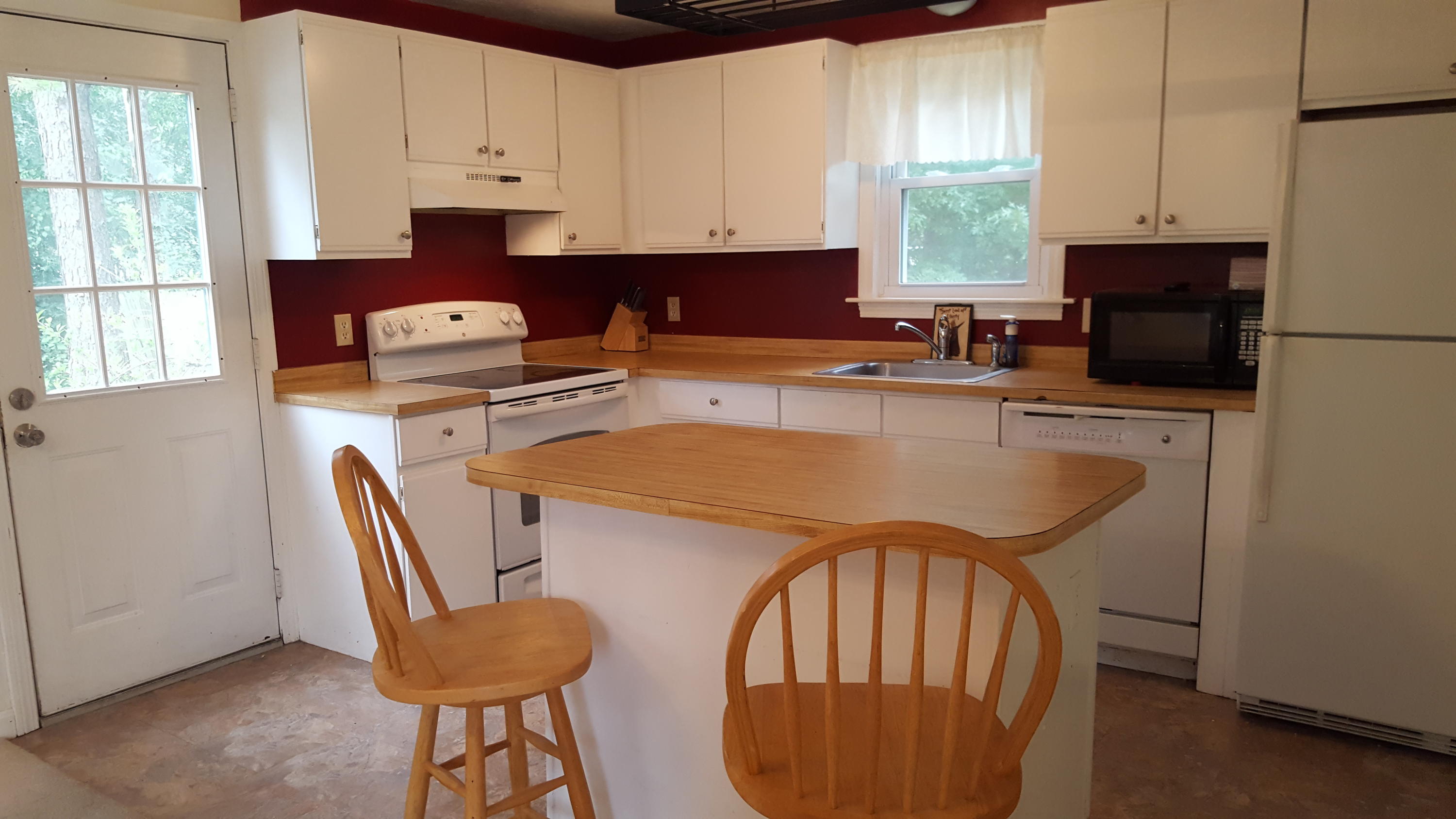 9 Pebble Path Forestdale, MA 02644 - Photo 6 of 21 a kitchen with stainless steel appliances granite countertop a stove a refrigerator a sink a dining table and chairs with wooden floor