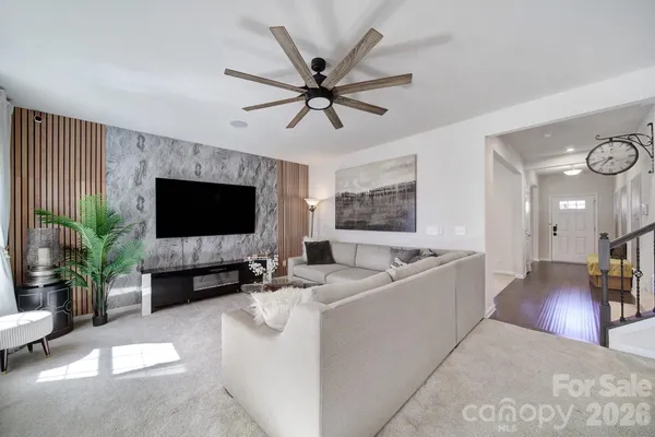 a spacious bedroom with a bed and a flat screen tv