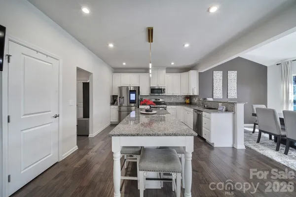 a spacious bedroom with a bed and a flat screen tv