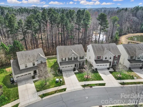 an aerial view of a house with a swimming pool and outdoor seating