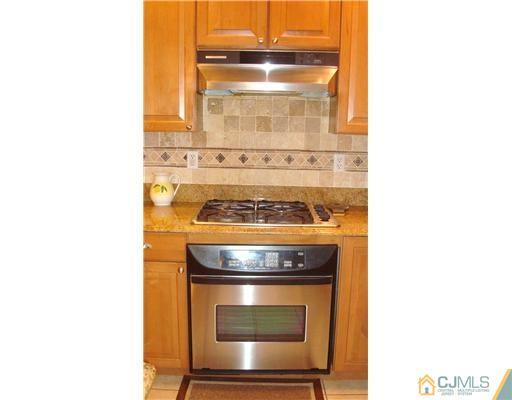7 Gramercy Road Monmouth Junction, NJ 08852 - Photo 12 of 25 a stove top oven sitting inside of a kitchen