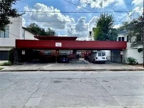 a red car parked in front of a house
