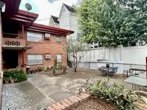 a view of a chairs and table in the back yard of the house