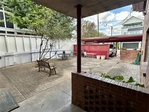 a view of a patio with table and chairs with wooden floor and fence