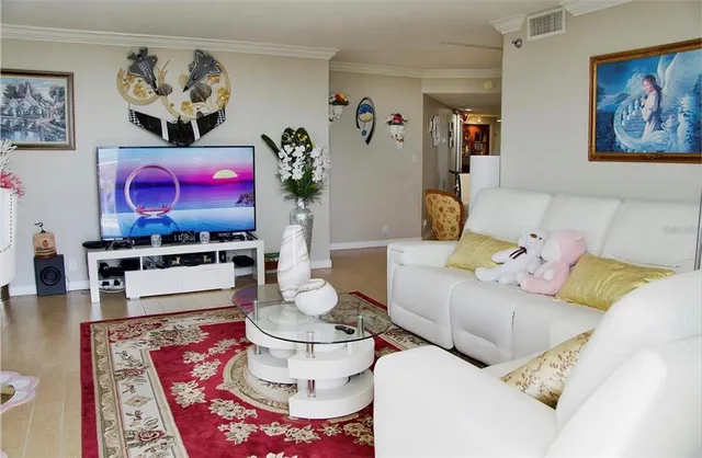 a living room with furniture and a dining area