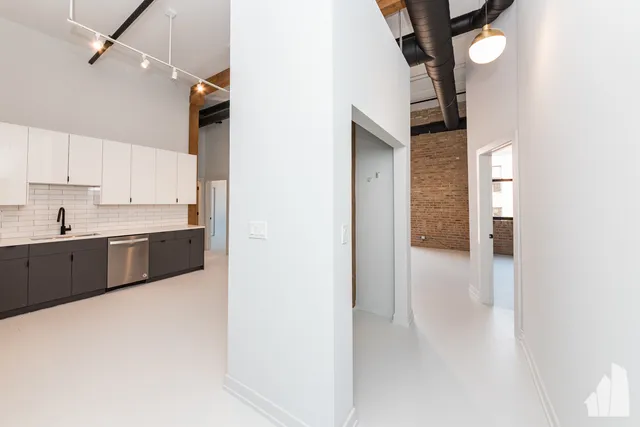 a view of a kitchen with a sink and cabinets