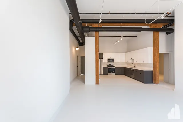 a view of a kitchen with a sink and cabinets