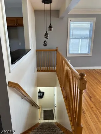 a view of an entryway with wooden floor
