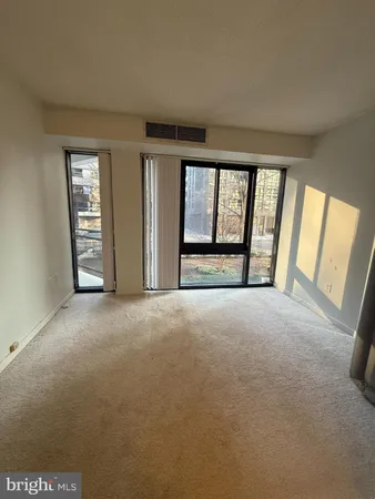 a view of an empty room with a fireplace and a large window
