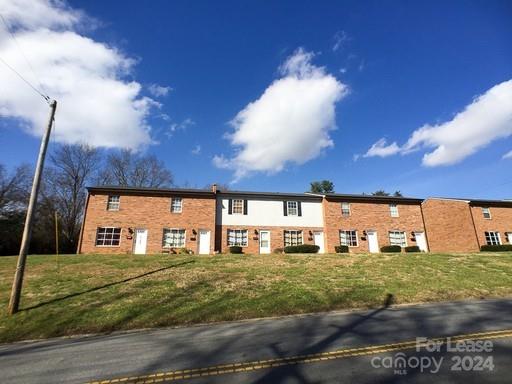 157 Brookwood Avenue Northeast, Unit 14 Concord, NC 28025 - Photo 1 of 1 a view of a building with a yard
