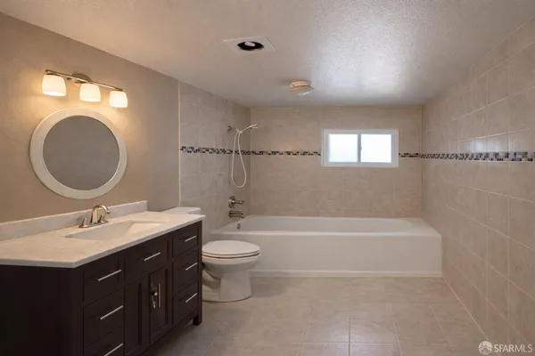a bathroom with a double vanity sink toilet mirror and bathtub