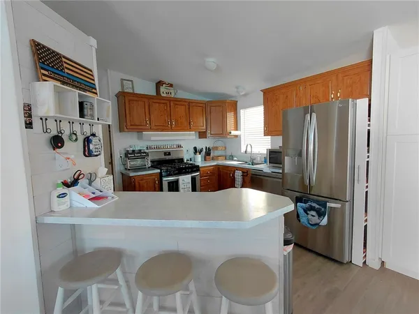 a kitchen with stainless steel appliances granite countertop a refrigerator and a stove top oven