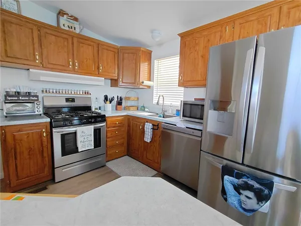 a kitchen with a refrigerator sink and cabinets