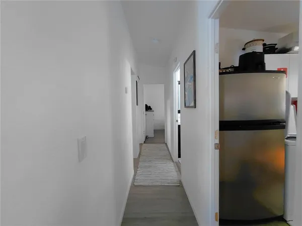 a view of a hallway with a refrigerator