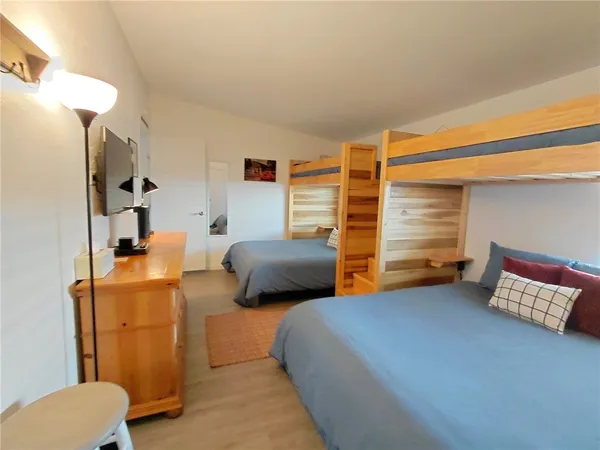 a bedroom with a bed and a chair