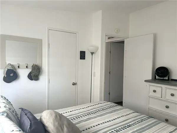 a bedroom with a bed and a dresser