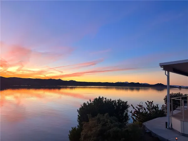 a view of a lake with houses in the back