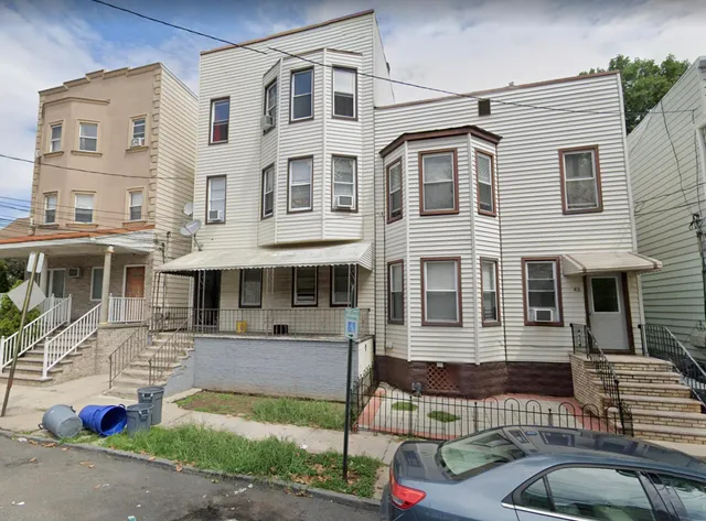 a front view of a building with windows and traffic signal