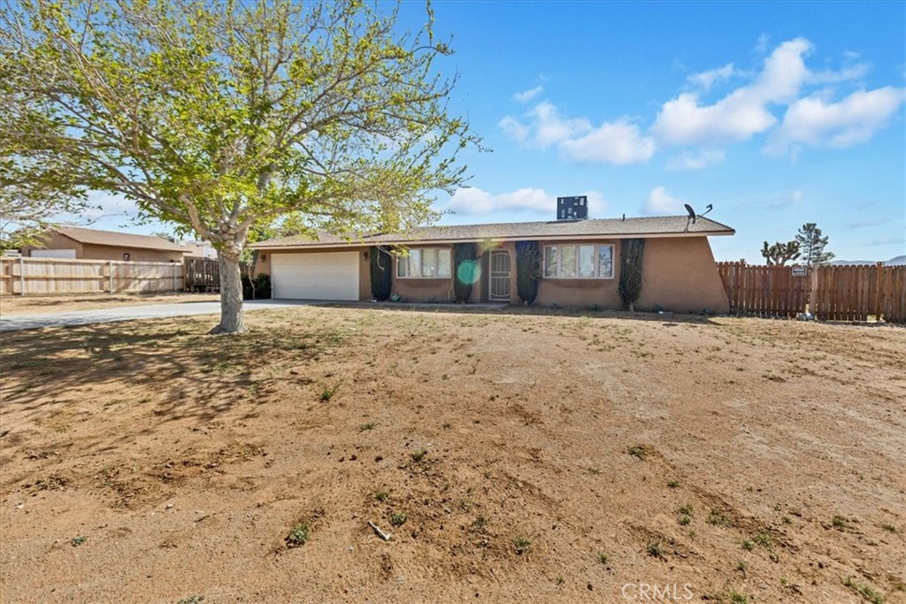 16731 Neenach Road Apple Valley, CA 92307 - Photo 1 of 1 a house with trees in front of it