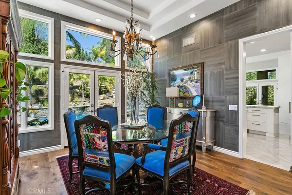 a dining room with furniture a painting and a chandelier