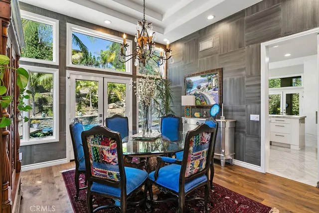 a dining room with furniture a painting and a chandelier