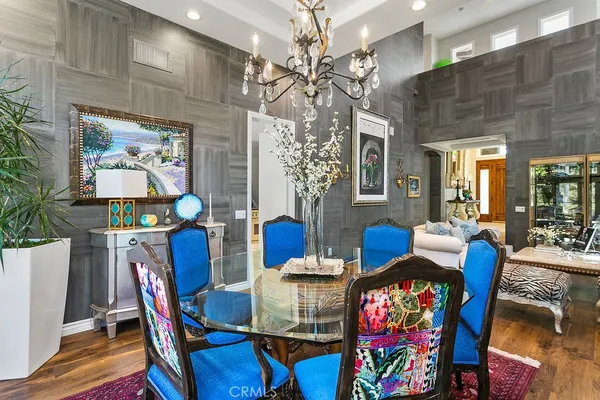 a view of a dining room with furniture and a chandelier
