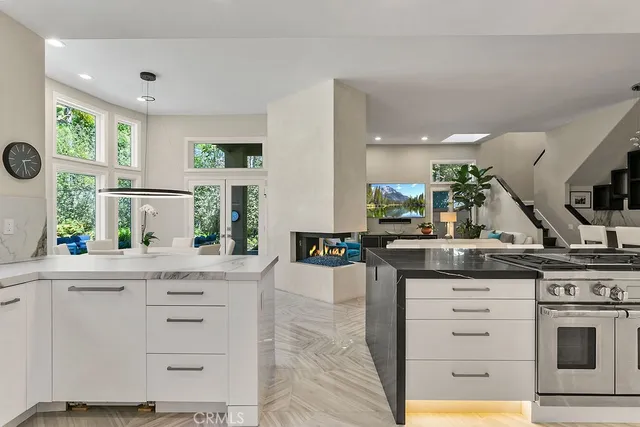 a kitchen with granite countertop a stove and a sink