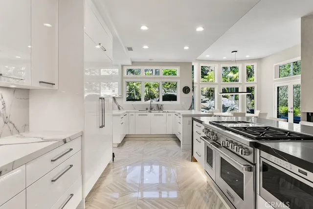 a kitchen with stainless steel appliances granite countertop a stove and a sink