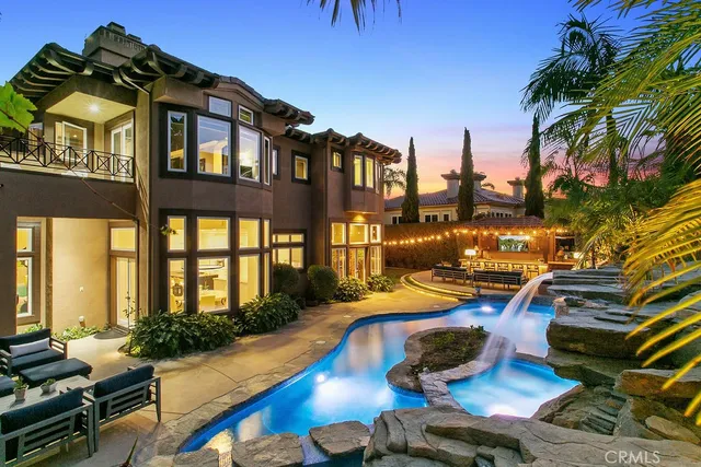 a view of a house with swimming pool and sitting area