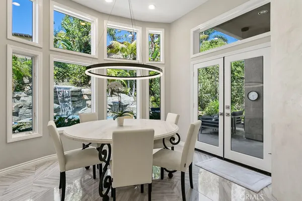 a living room with furniture a dining table and chairs in it