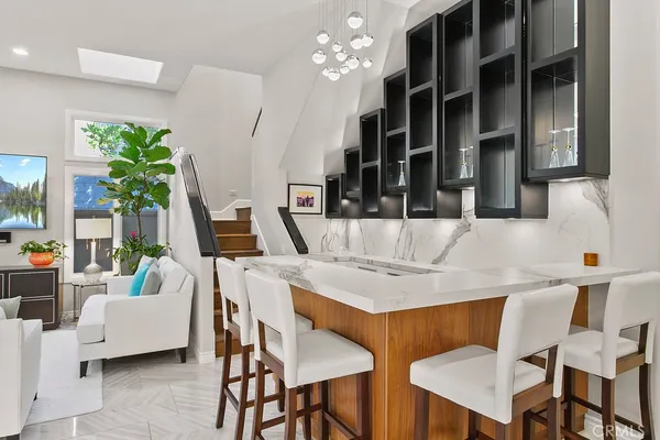 a bathroom with a granite countertop sink toilet and mirror