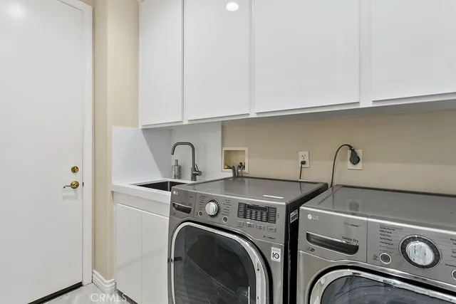 a spacious bathroom with a double vanity sink a toilet and a mirror