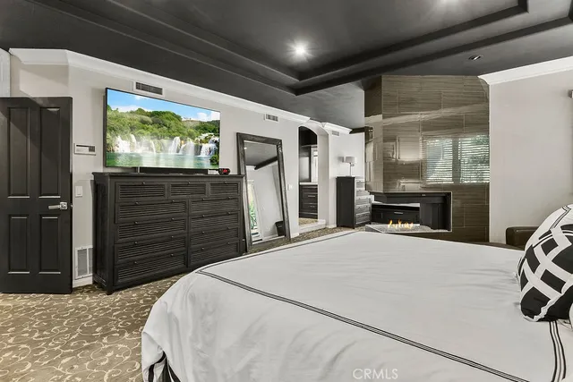 a bedroom with a bed and a dresser