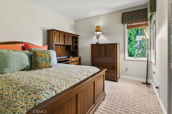 a view of a house with backyard water fountain and sitting area