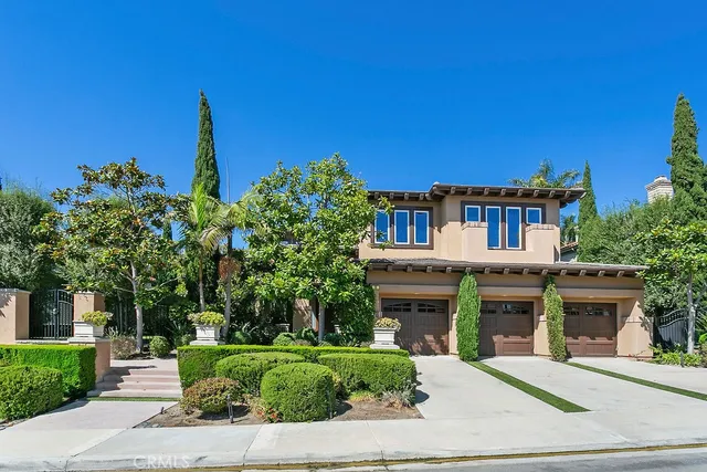 a front view of a house with a garden